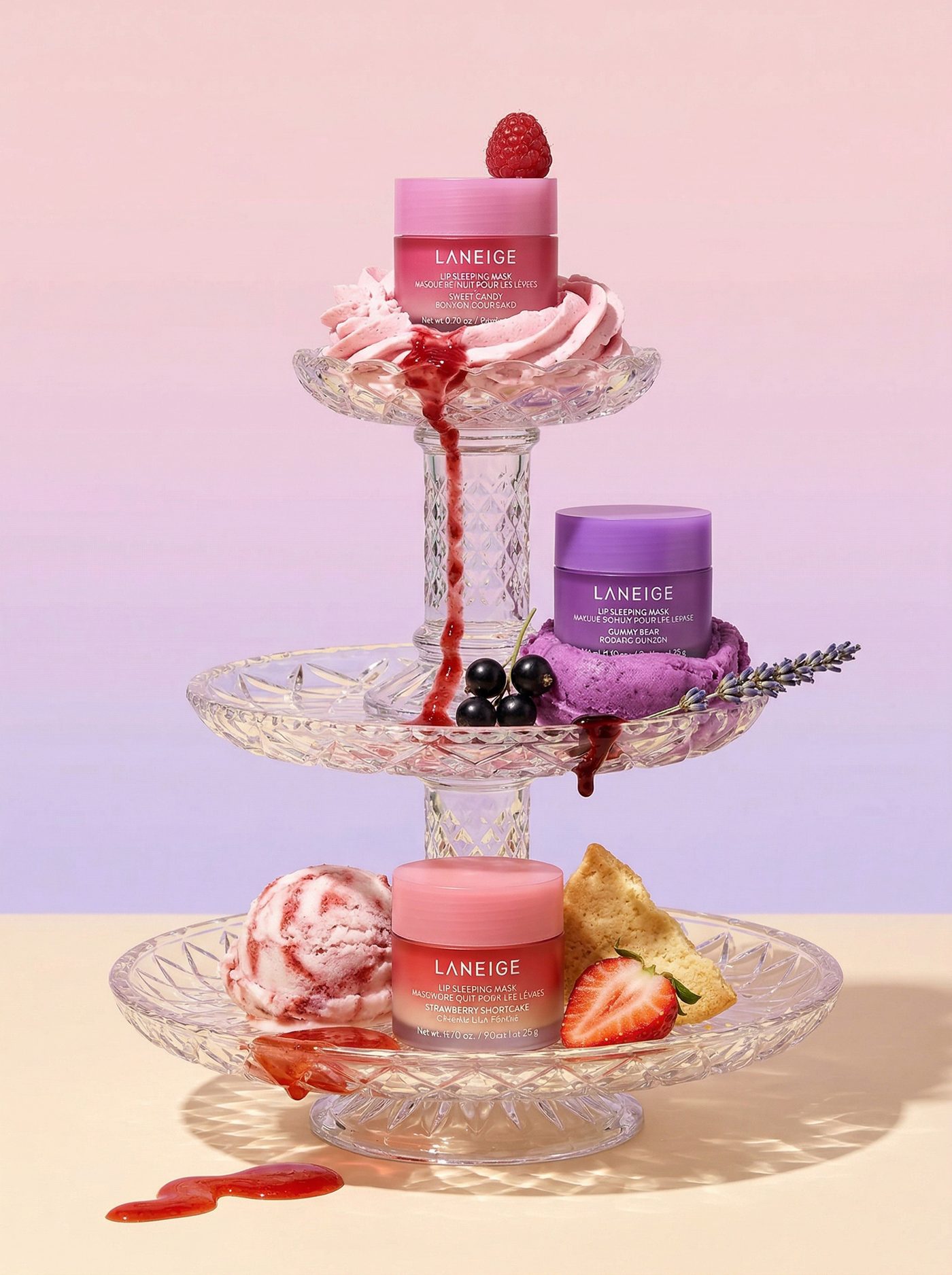 A tiered glass stand of sorbets and beauty jars with syrup running over the edge