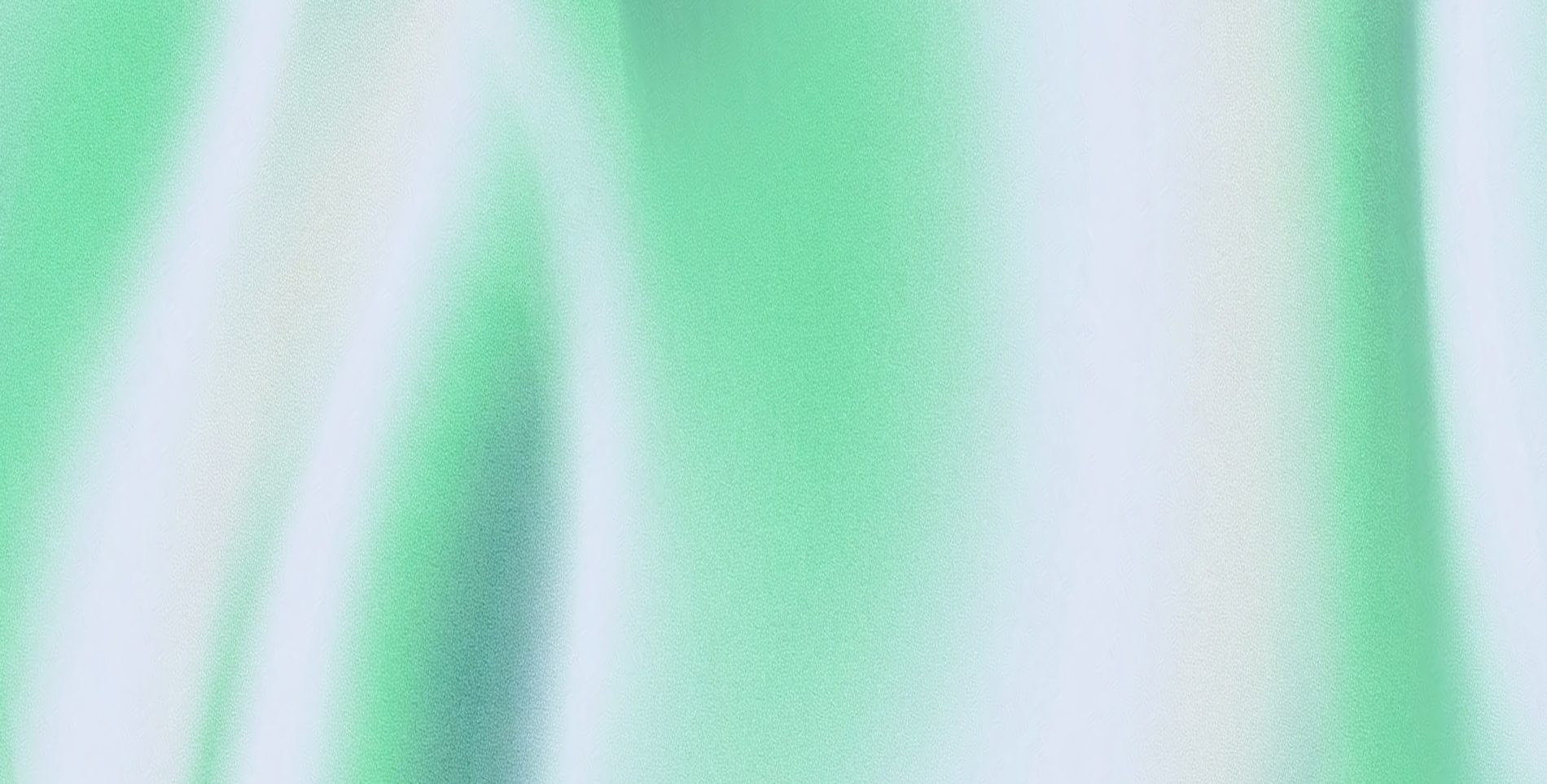 A field of green and white silk folds catching the light
