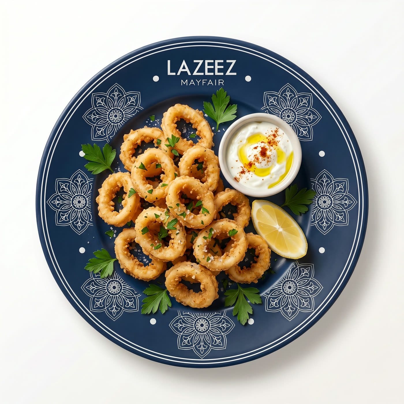 A navy Lazeez Mayfair plate of calamari rings with dip and a lemon wedge