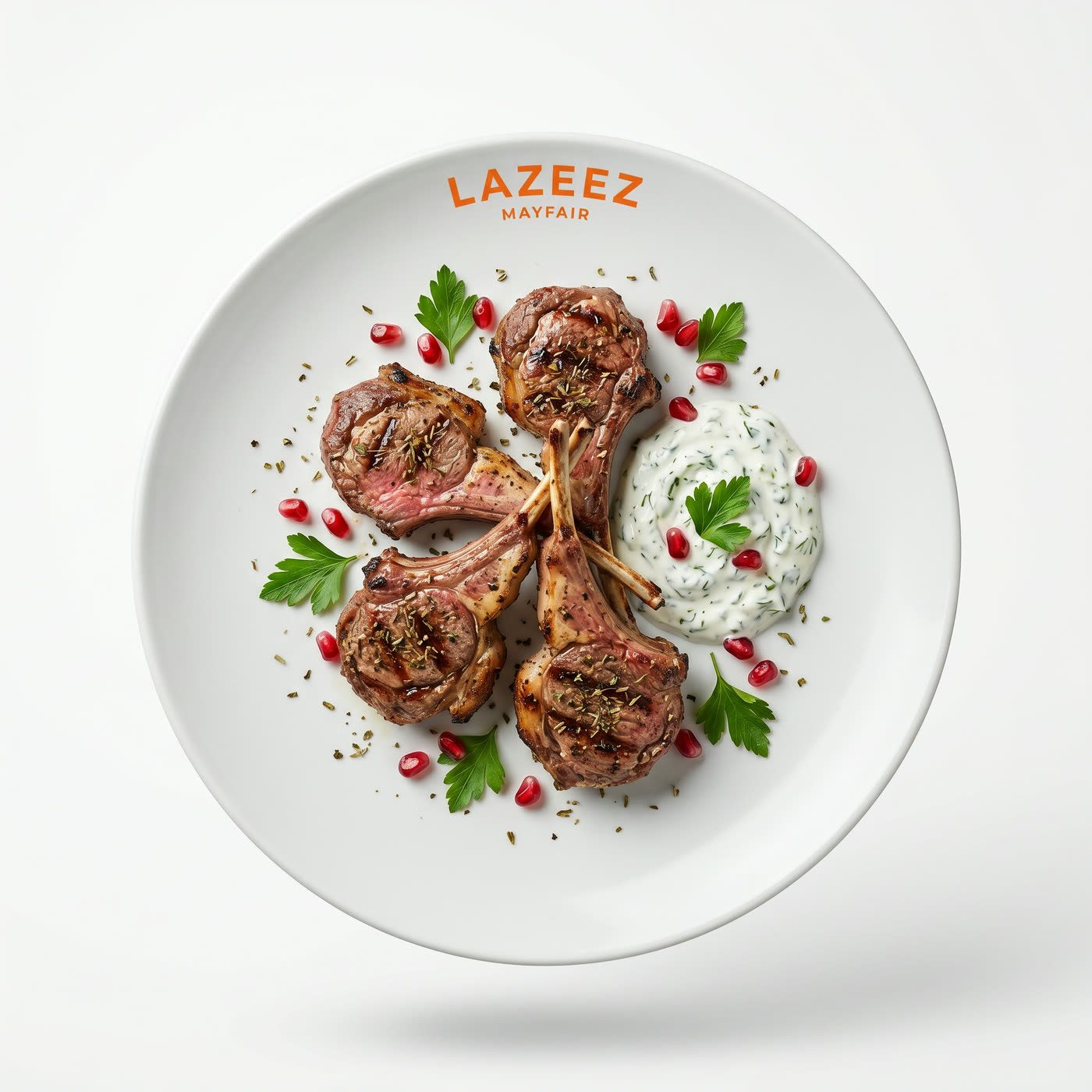 A white Lazeez Mayfair plate of lamb chops with yoghurt and pomegranate